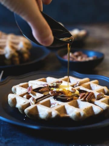 pouring syrup on banana flour waffles