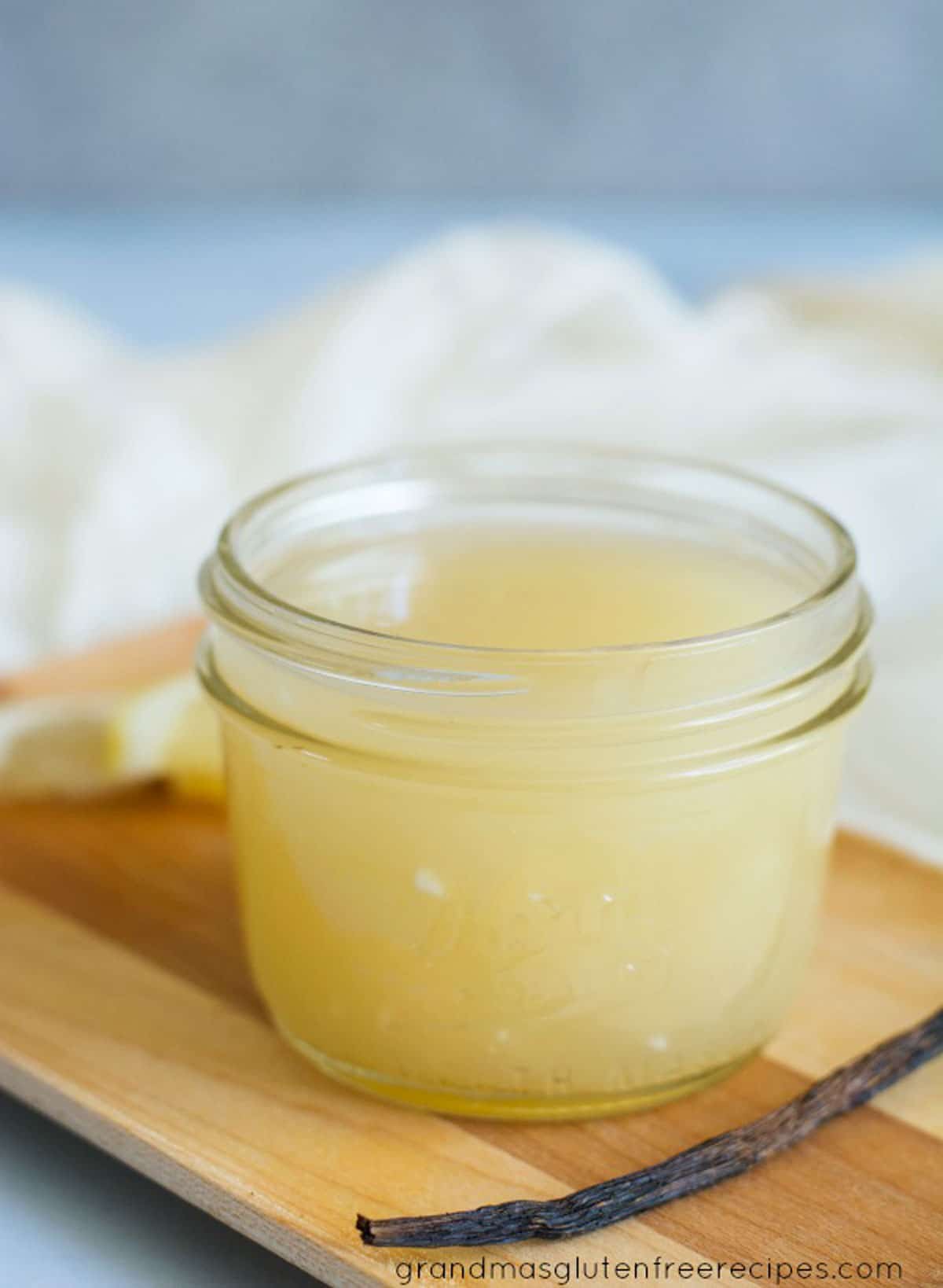 A small mason jar of vanilla cream sauce.