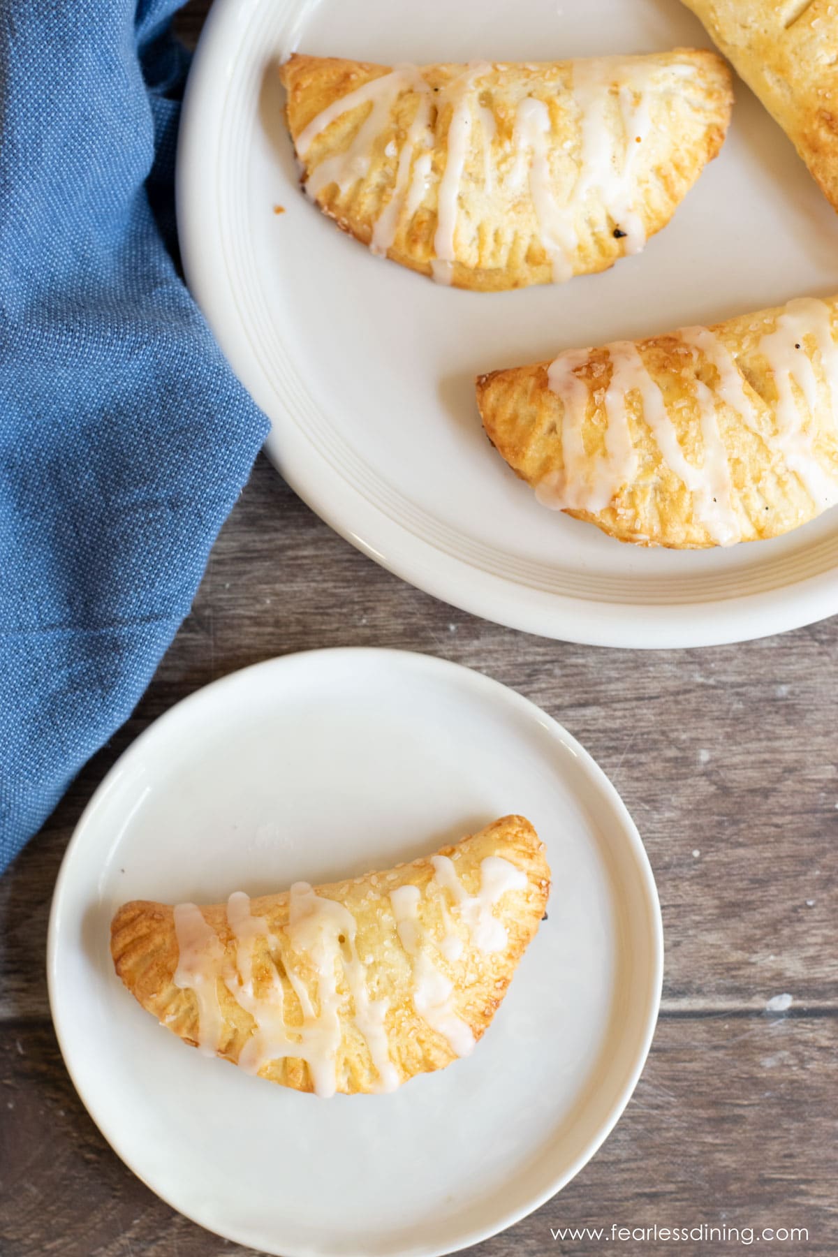 The top view of two plates full of air fried hand pies.