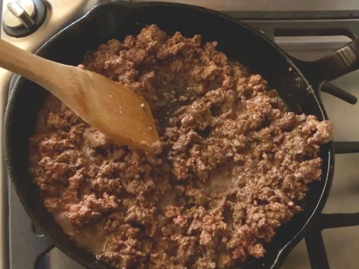 Browning the taco meat in a cast iron skillet.