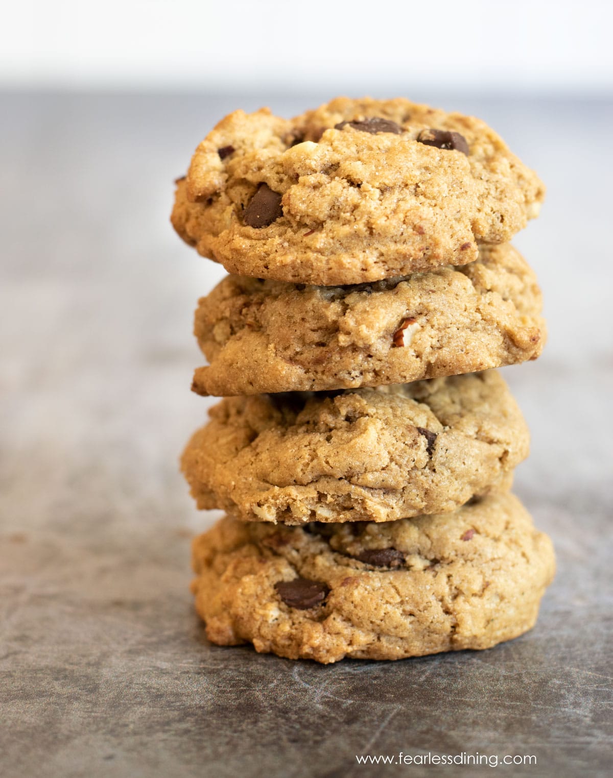 A stack of four chocolate chip hazelnut cookies.