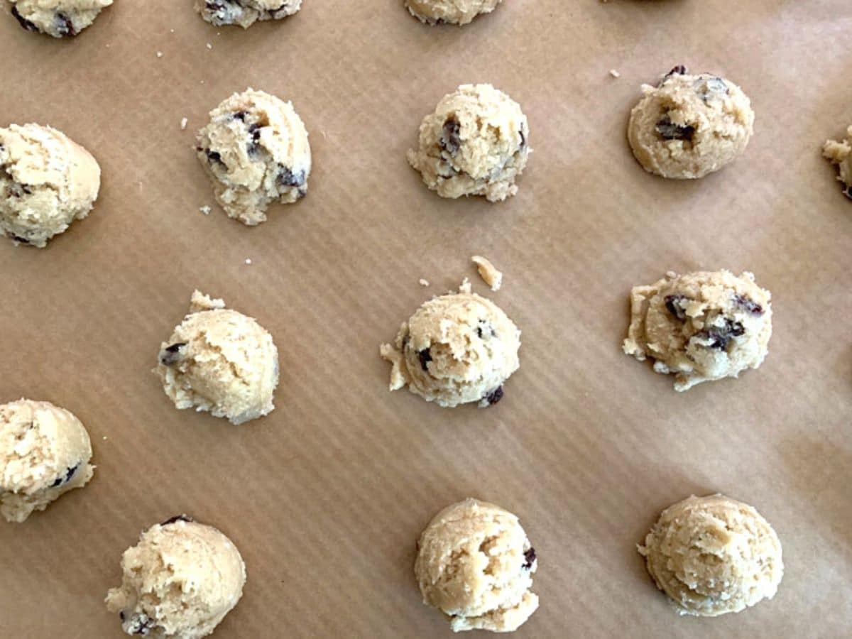 Cookie dough balls on a cookie sheet ready to bake.