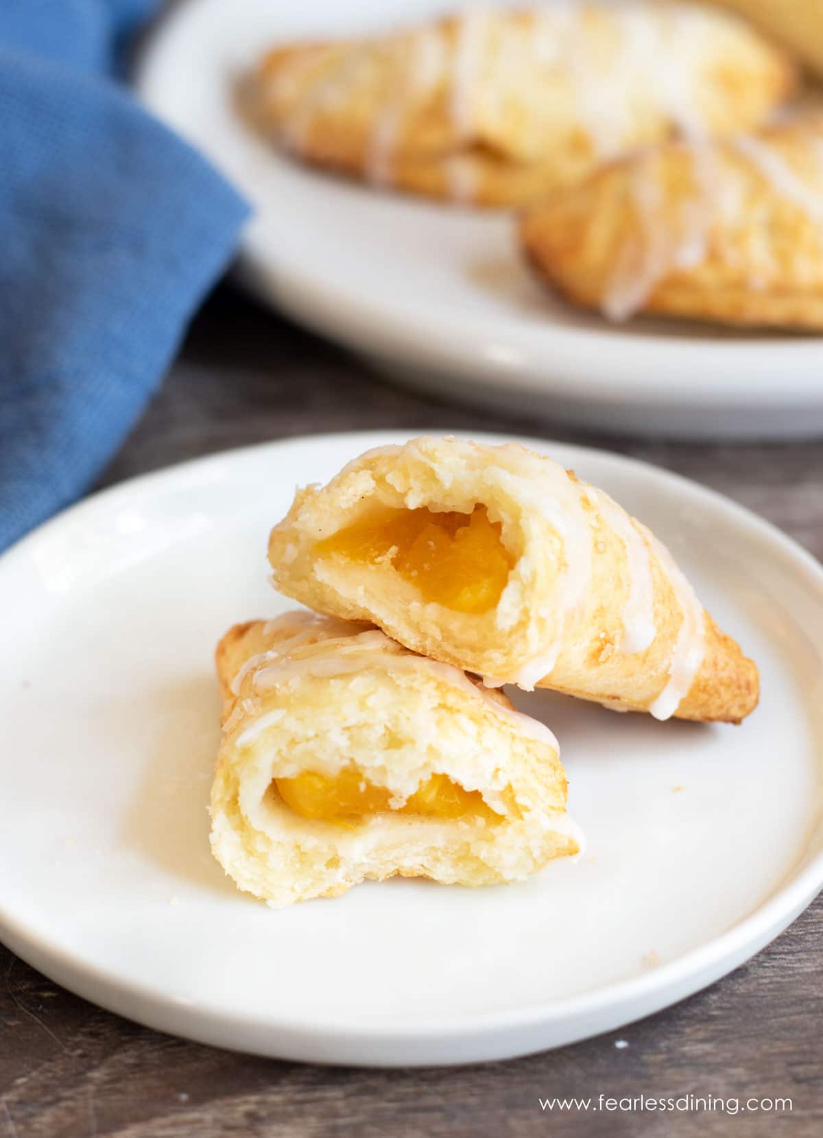 A gluten free air fried hand pie cut in half on a plate.