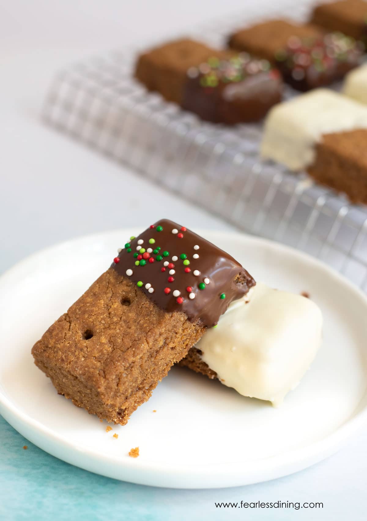 two pieces of gluten free gingerbread shortbread on a small plate