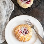 A raspberry kolache on a plate.