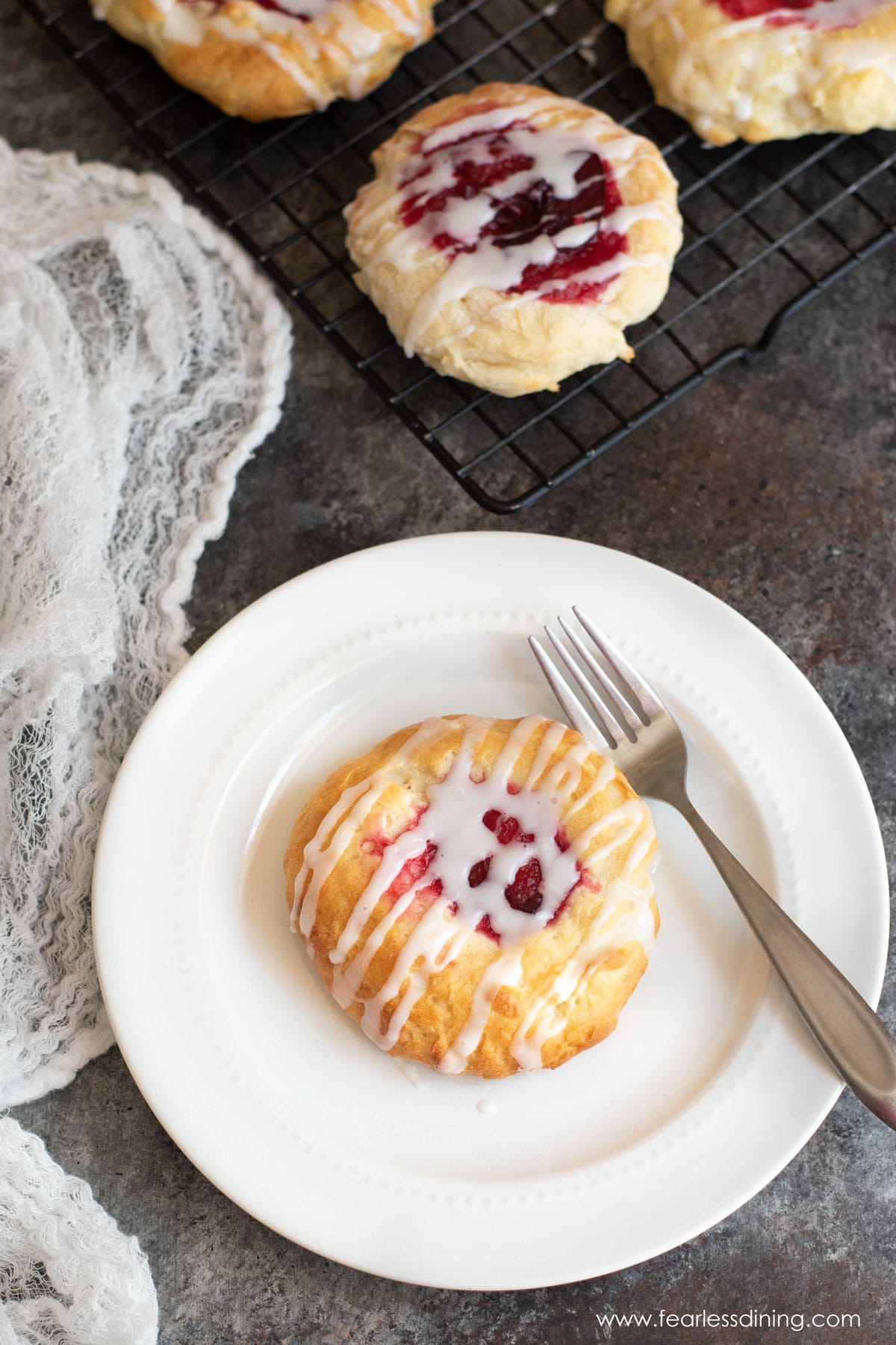 A raspberry kolache on a plate.