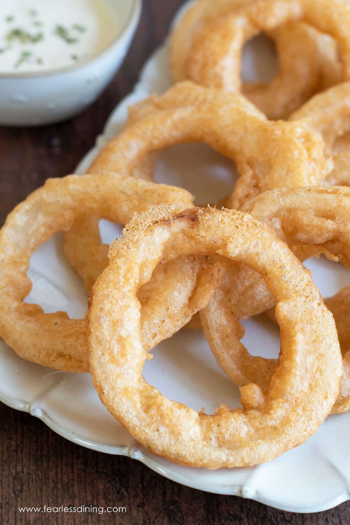 Gluten free beer battered onion rings on a platter.