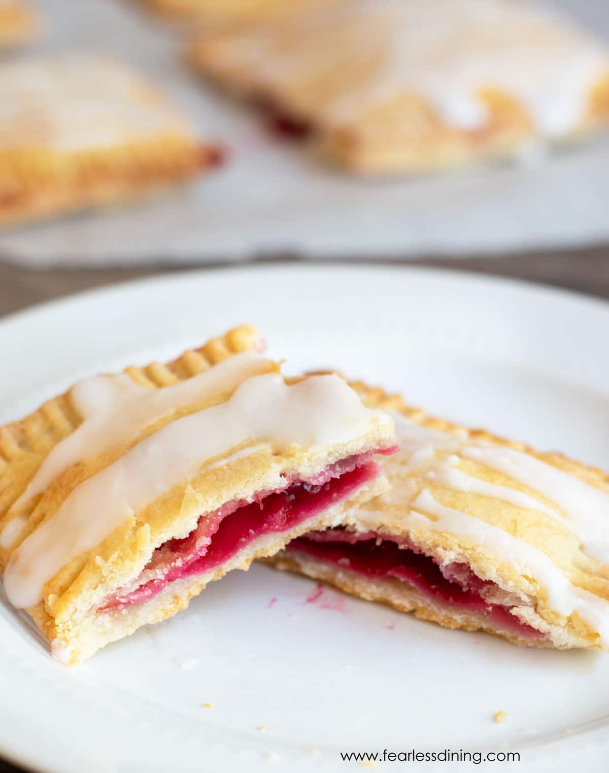 A pop tart cut in half on a plate.