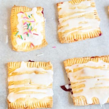 Frosted gluten free pop tarts on parchment paper.