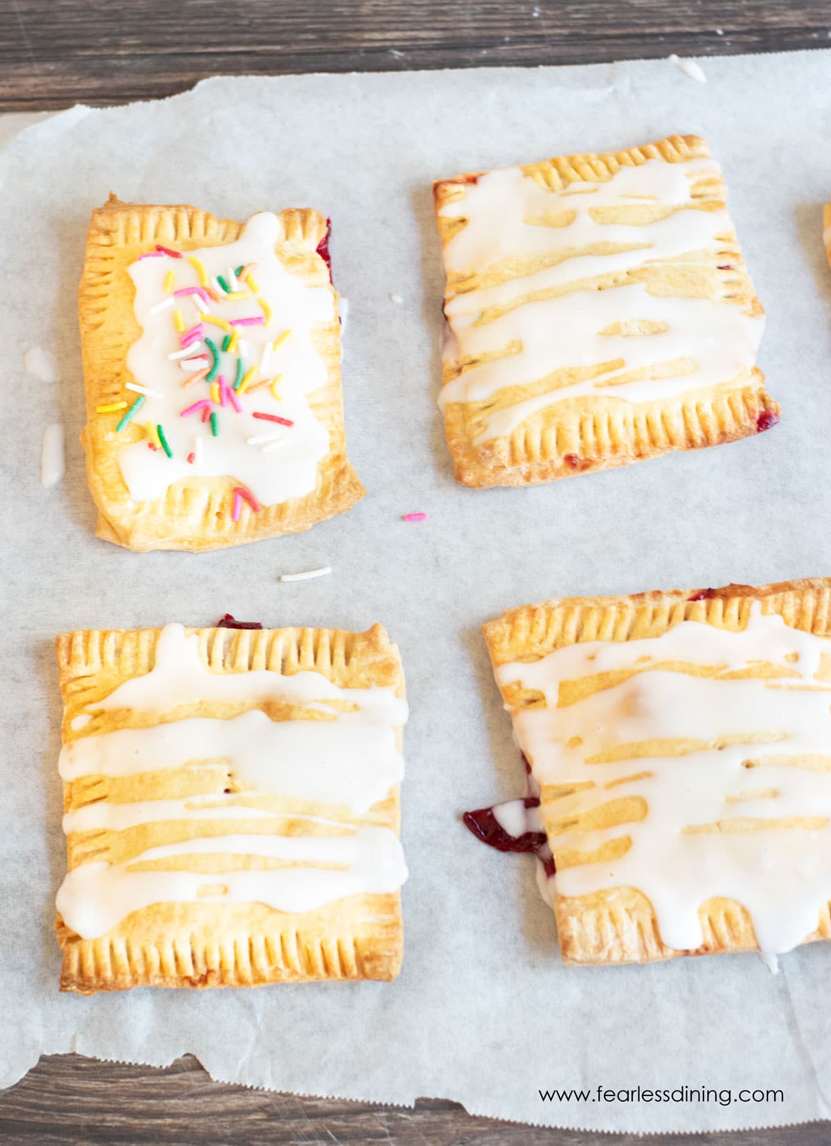 Frosted gluten free pop tarts on parchment paper.