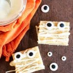 White chocolate brownies decorated with candy eyes for Halloween.