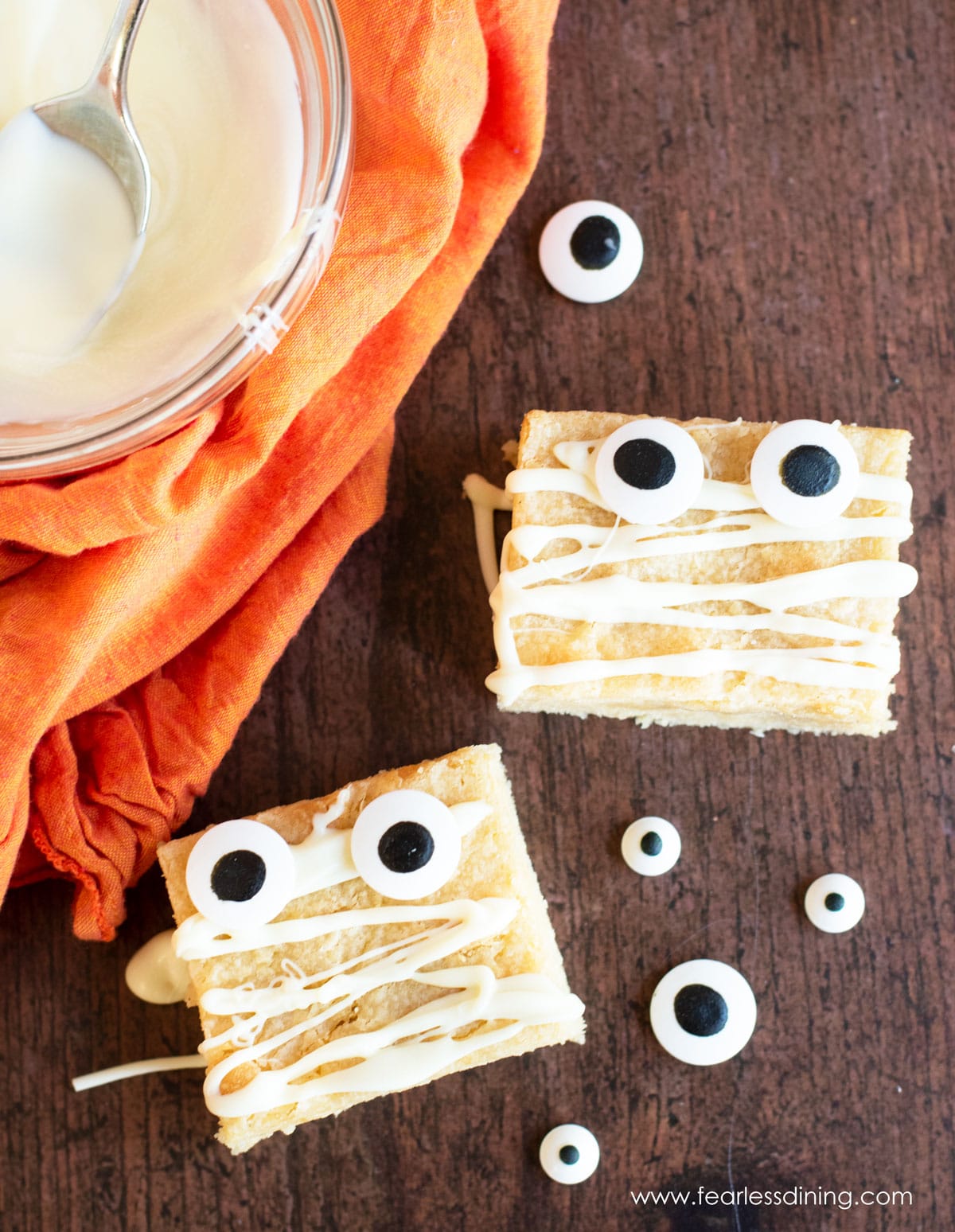 White chocolate brownies decorated with candy eyes for Halloween.