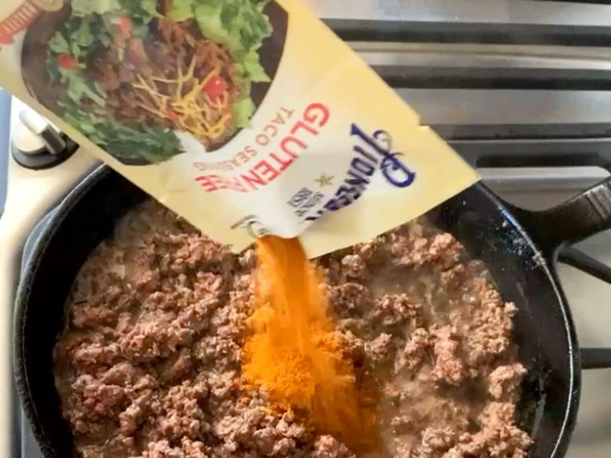 pouring in the taco mix
