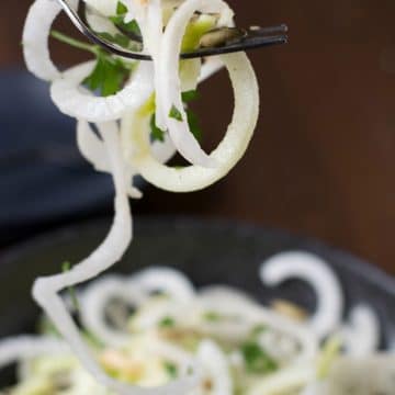 A fork full of daikon salad spirals.