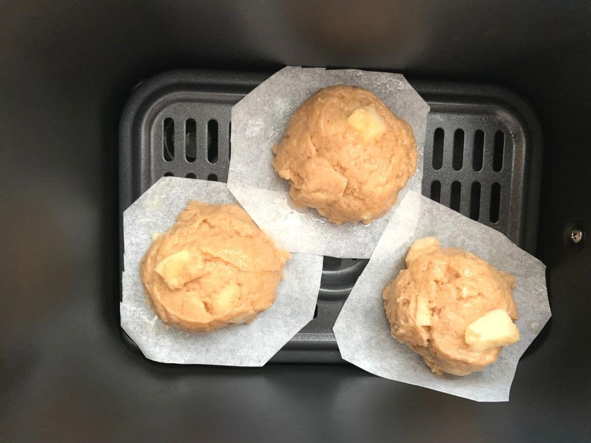 A photo of the apple fritter dough balls in the air fryer.