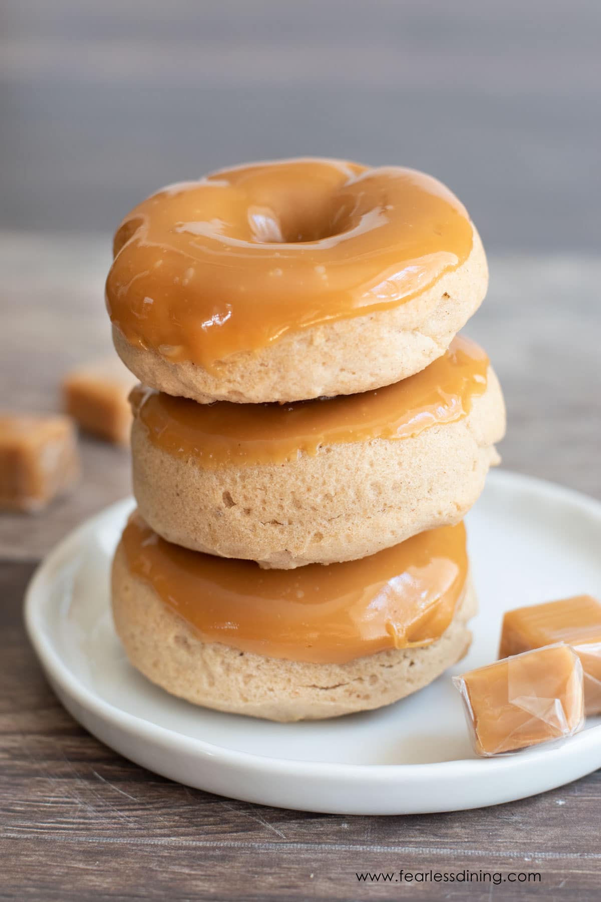 A stack of three caramel apple donuts.