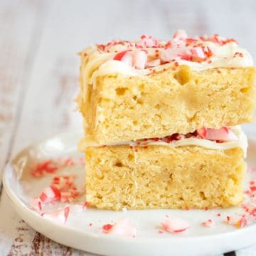 Two gluten-free peppermint brownies on a white plate.