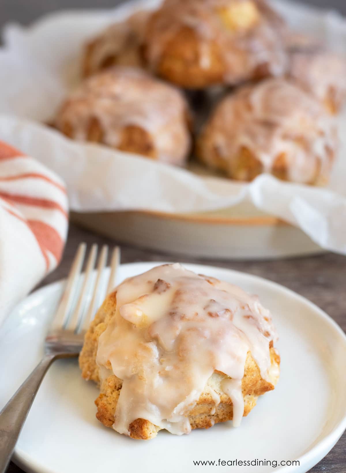 An gluten-free apple fritter on a white plate.