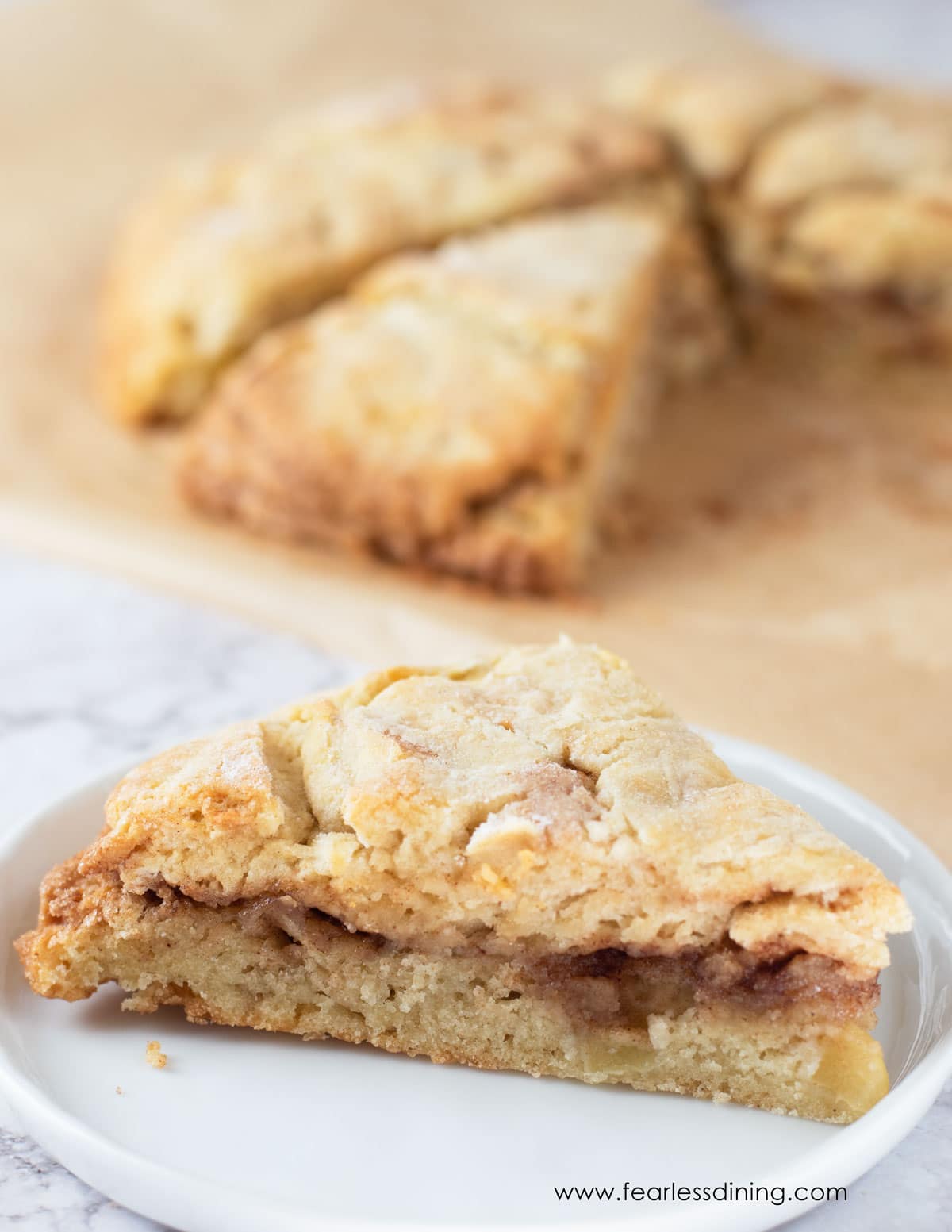 A gluten free cinnamon apple scone on a plate.