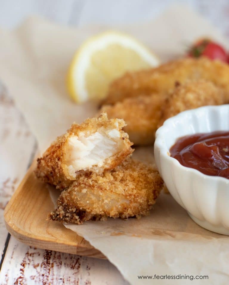 A crispy gluten free fish stick cut in half.