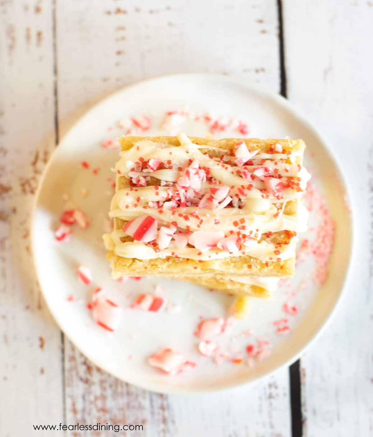 Two peppermint brownies stacked on a plate.