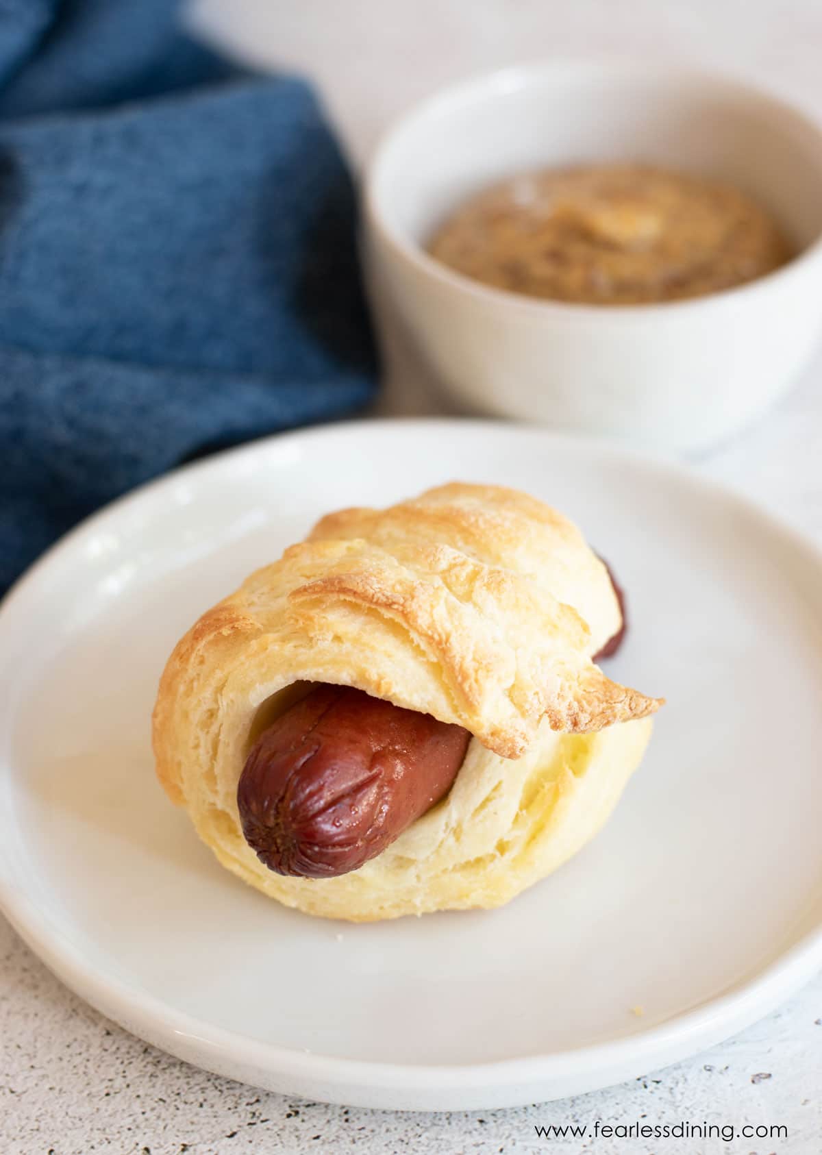 A gluten free pig in a blanket on a plate.