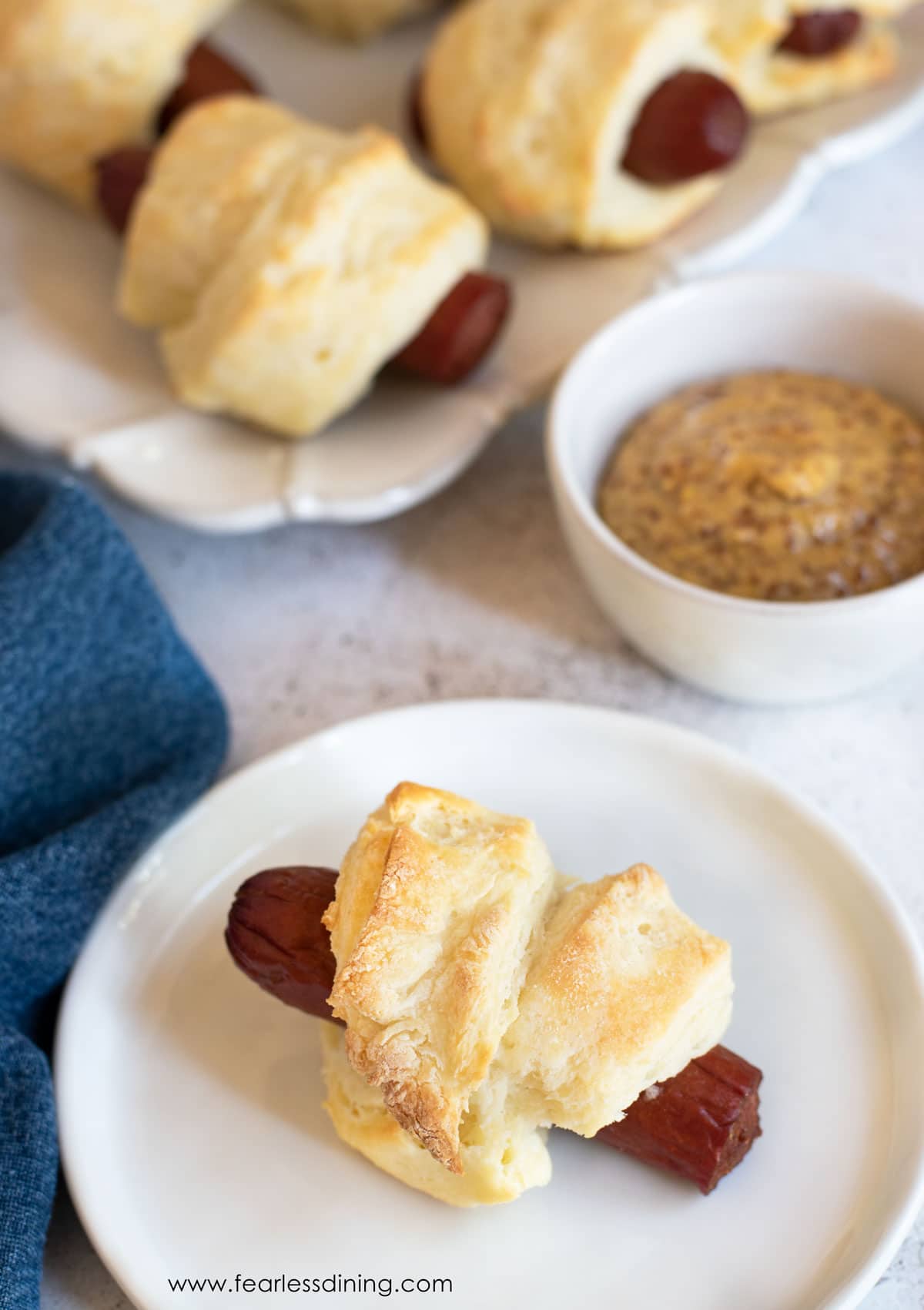 Baked pigs in a blanket on a tray.