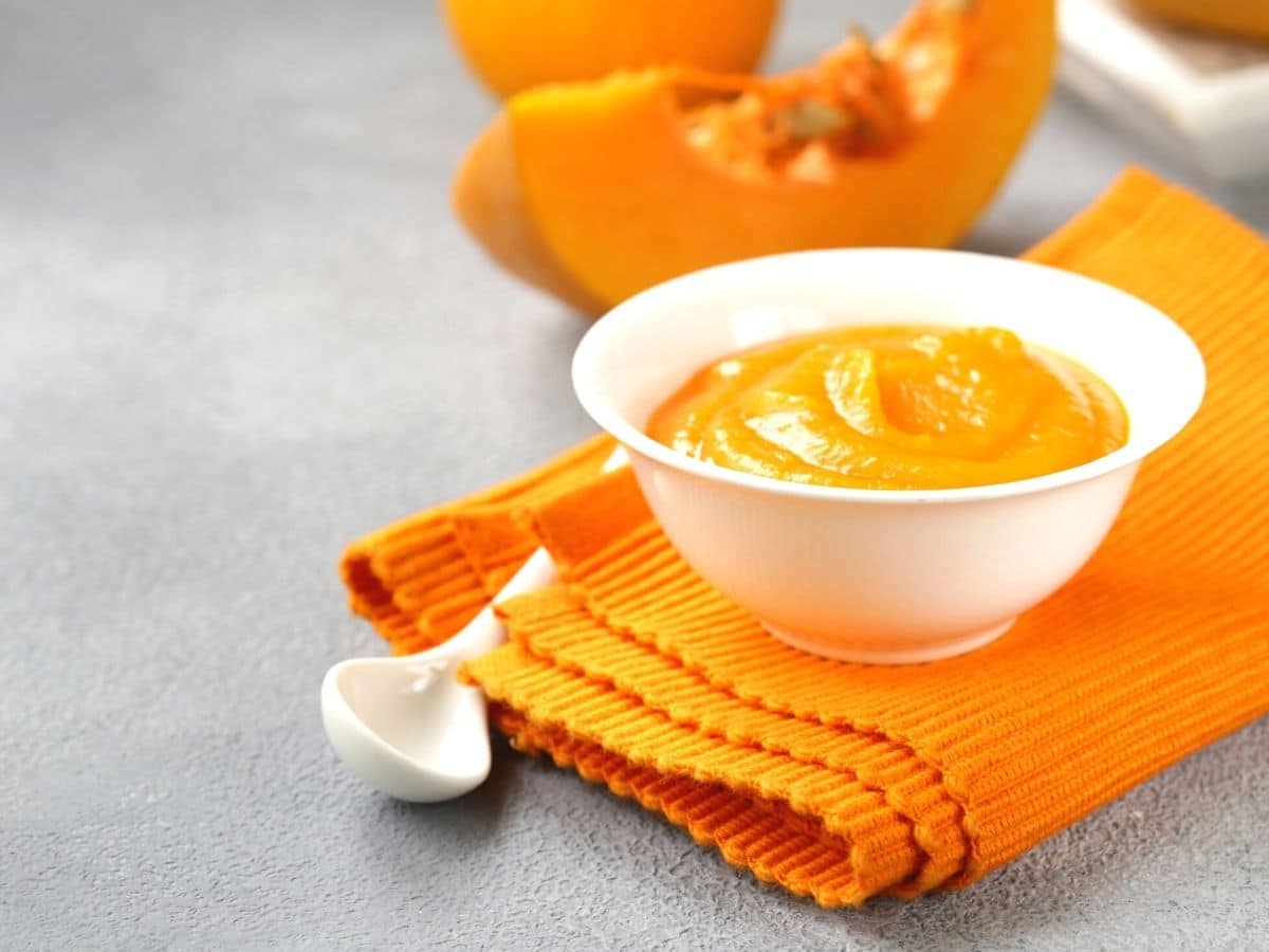 A white bowl filled with pumpkin puree.