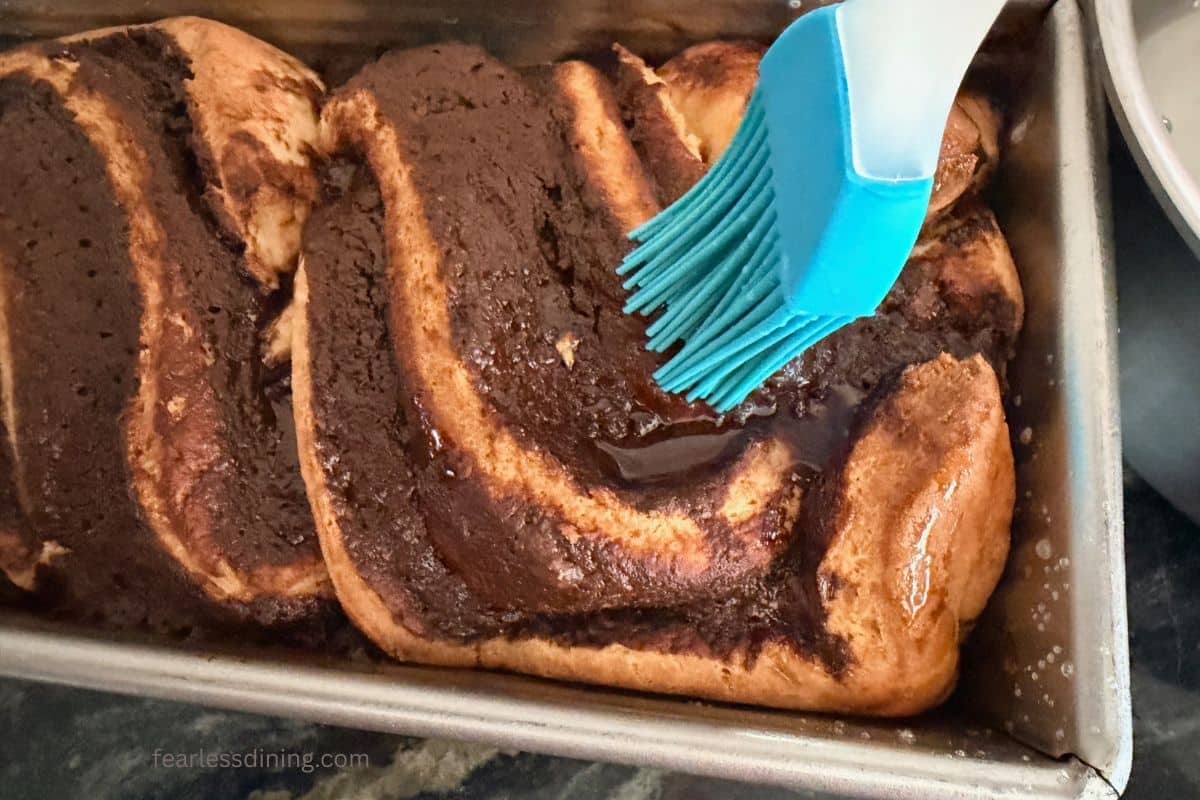 Brushing the glaze on the baked babka.