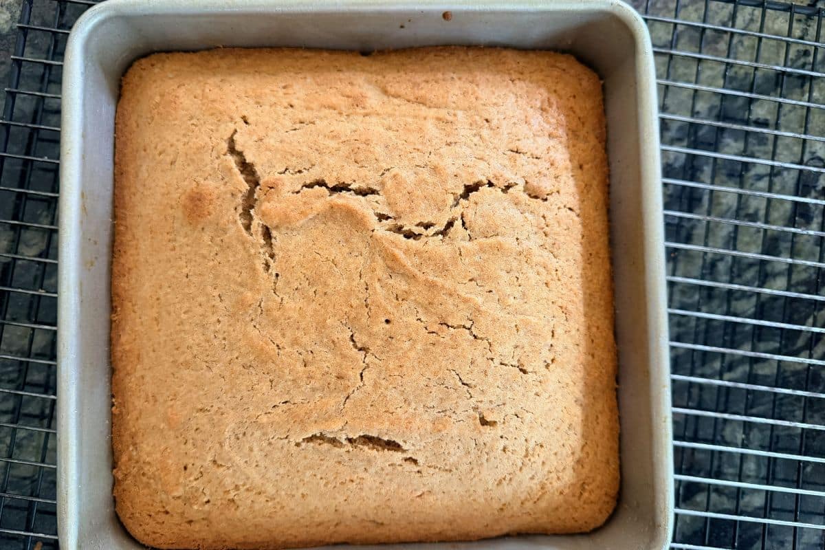 The baked cake in an 8x8 baking tin.