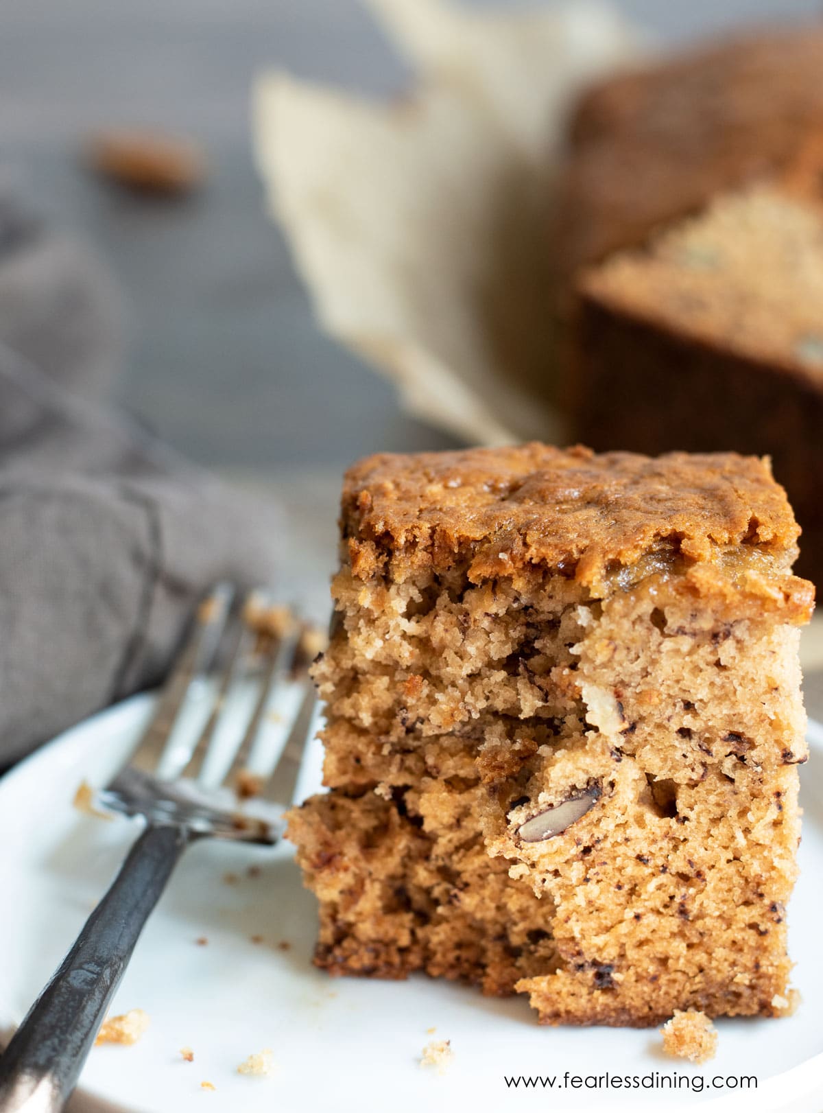 a slice of gluten free banana cake with a bite cut out