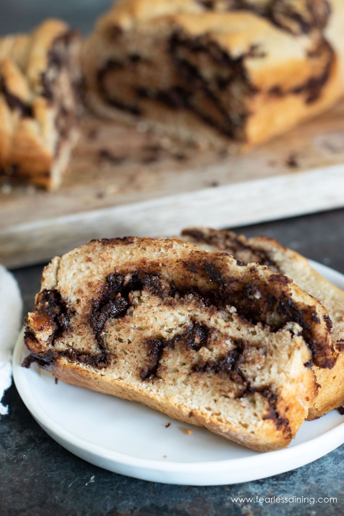 A slice of gluten free chocolate babka on a white plate.