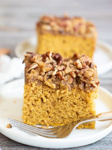 Two slices of pumpkin coffee cake on white plates.