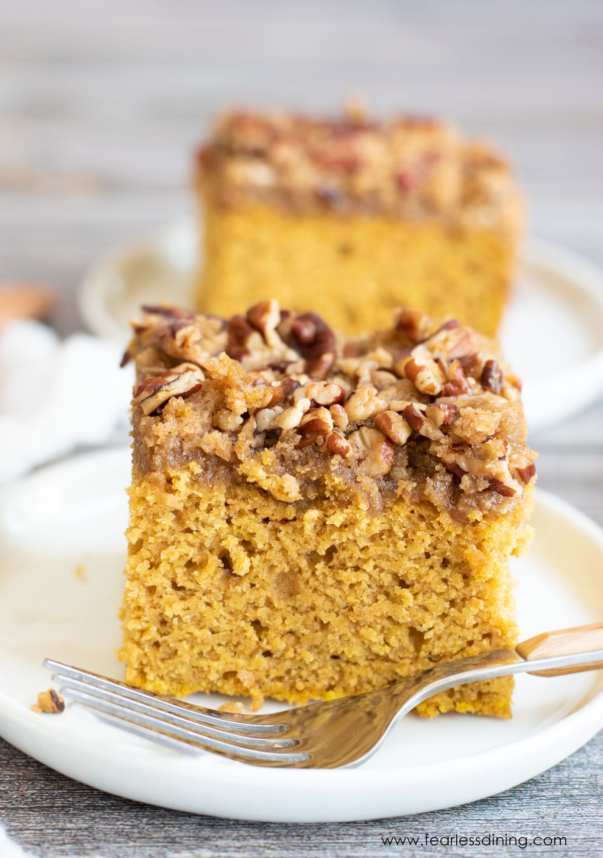 two slices of pumpkin coffee cake on white plates
