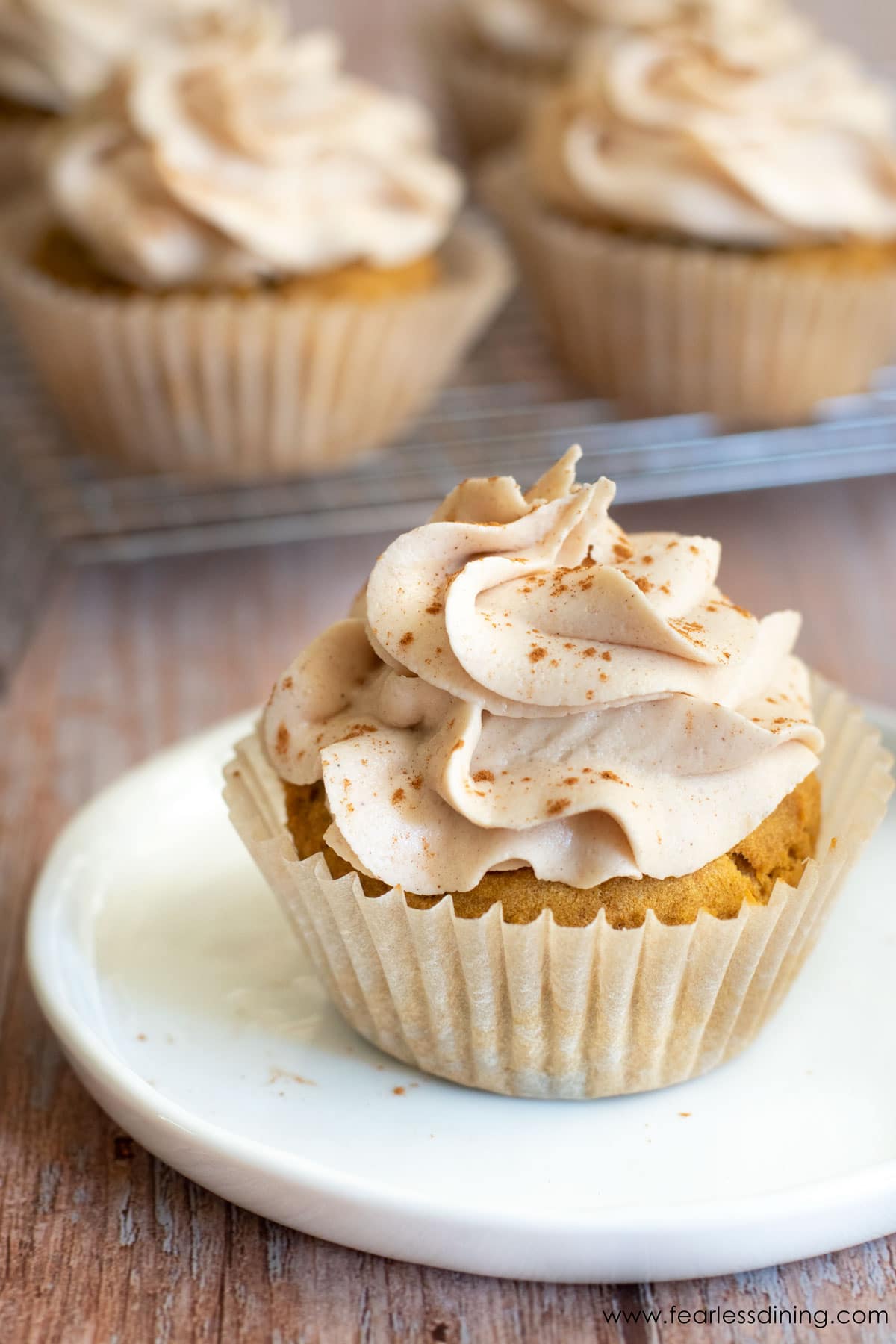 A gluten free cupcake on a small white plate.