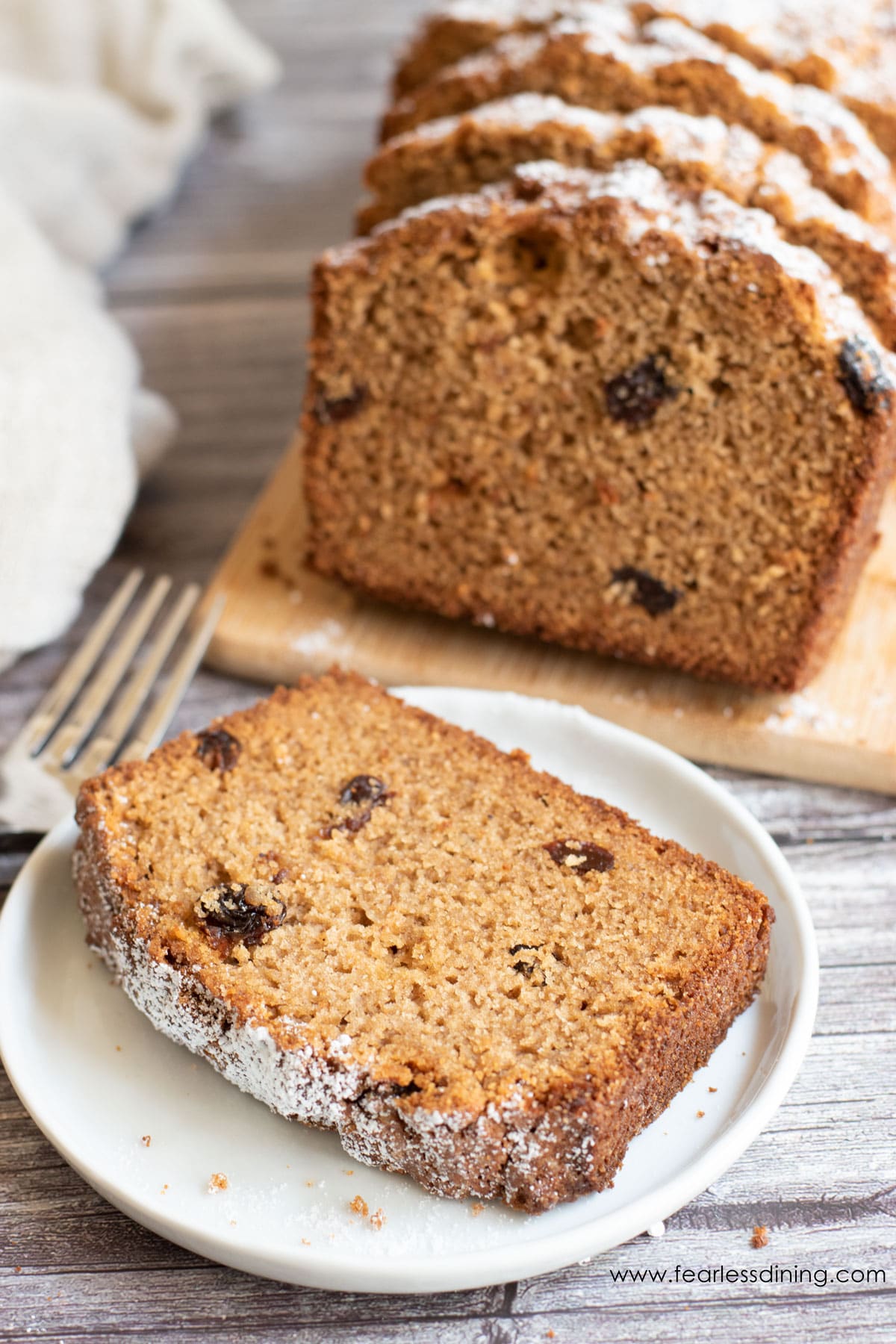 A slice of gluten free spice cake on a white plate.