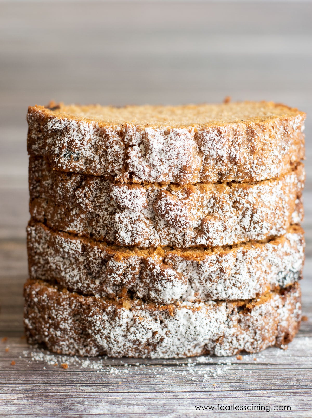 A stack of four slices of gluten free spice cake.