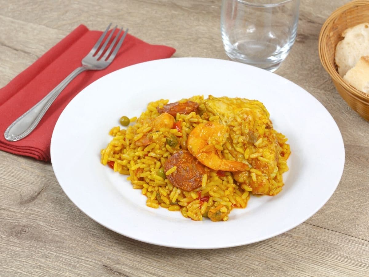 A plate of paella on the dinner table.