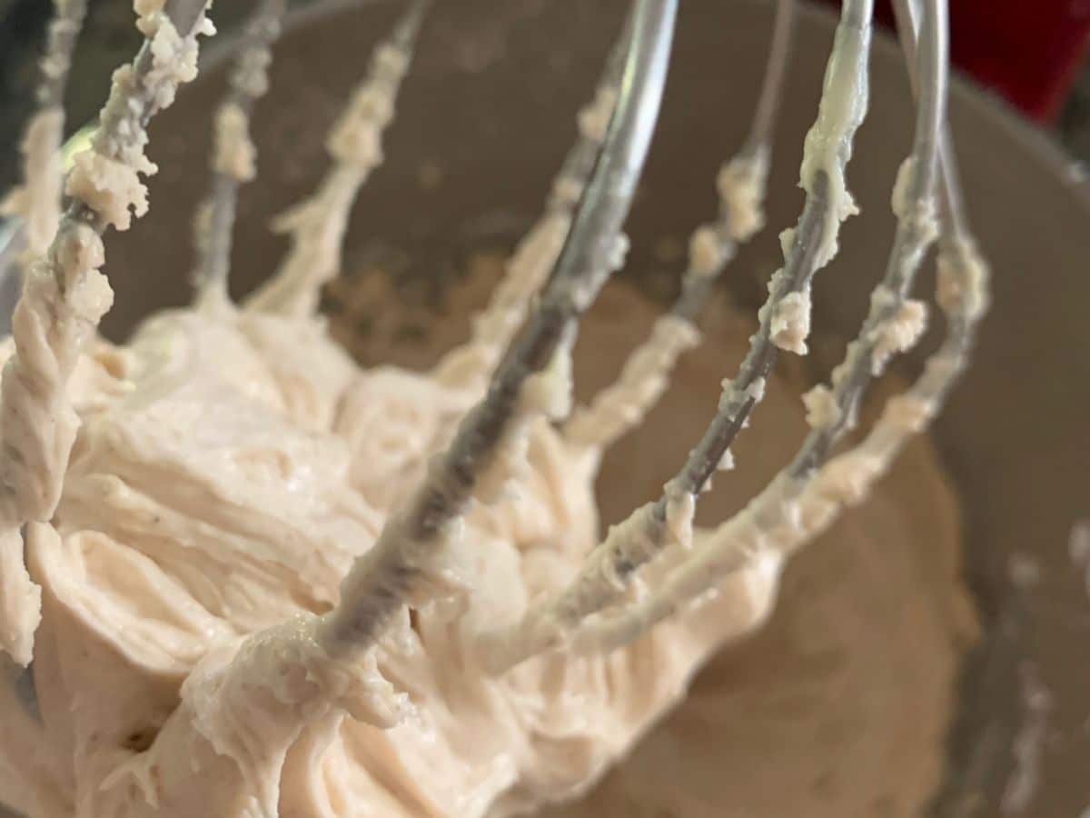 The cinnamon frosting on a standing mixer beater.