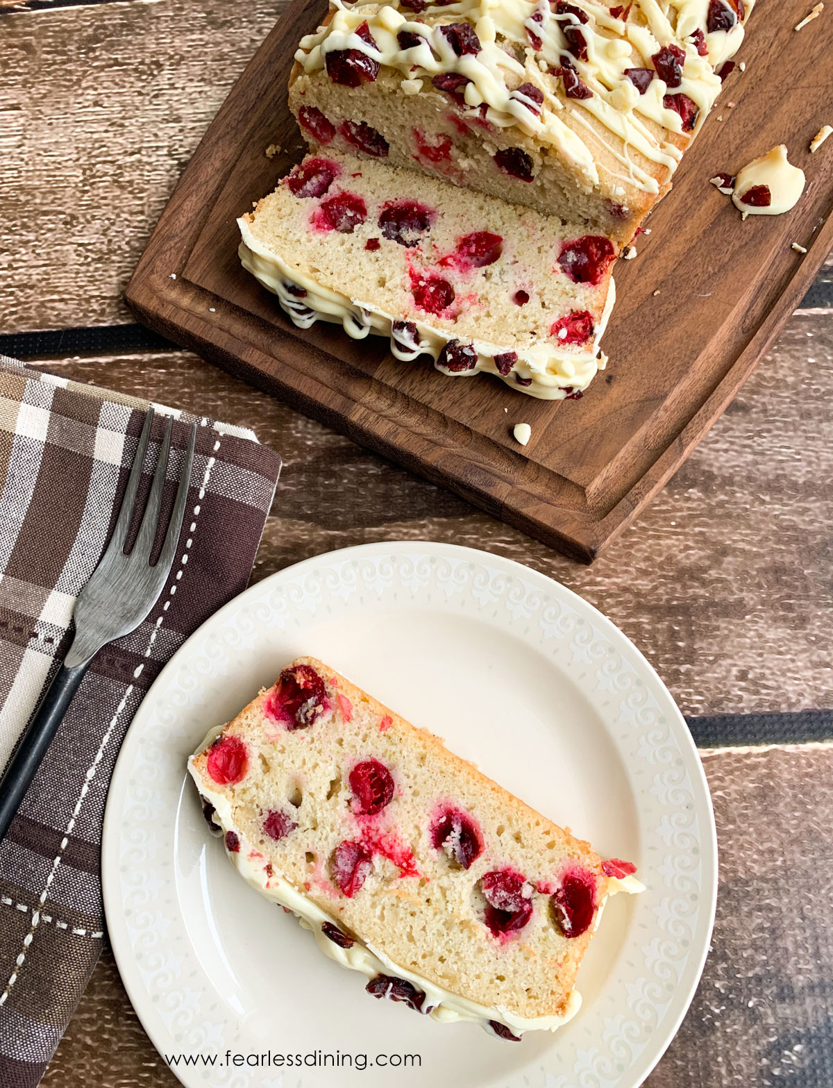A slice of gluten free cranberry cake on a plate.
