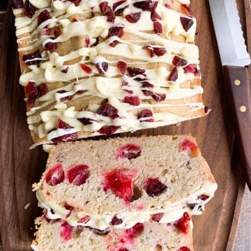 A sliced cranberry pound cake on a cutting board.