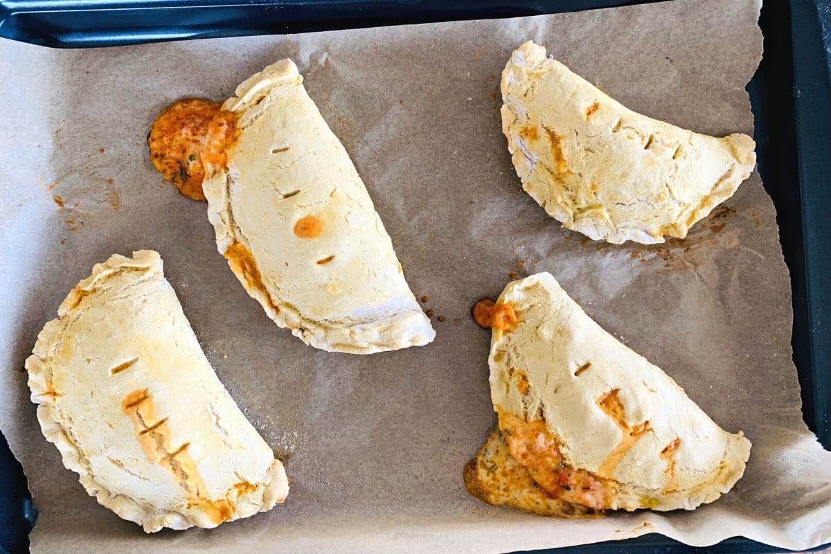 baked calzones on a tray