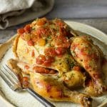 A slow cooker cornish hen on a plate.