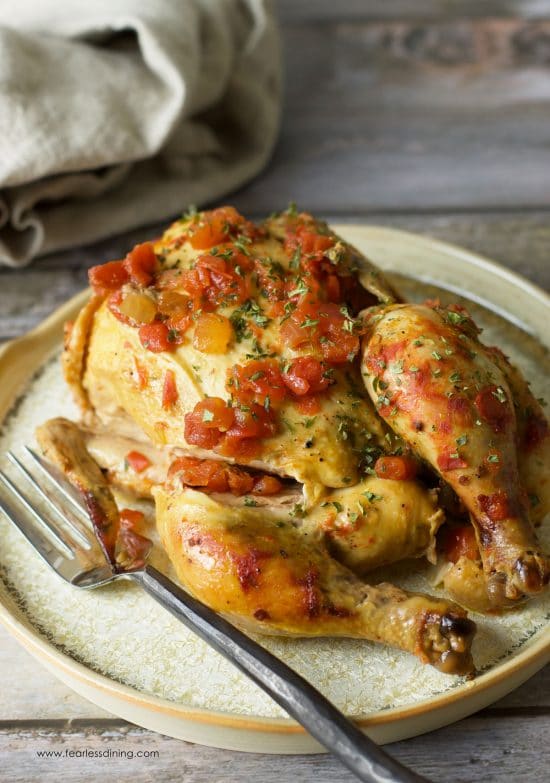 A slow cooker cornish hen on a plate.