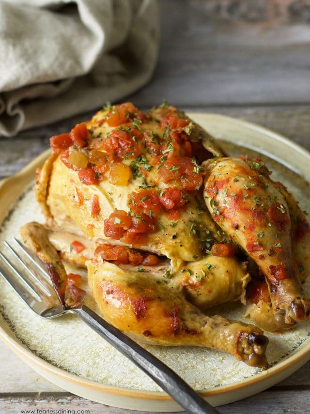 A slow cooker cornish hen on a plate.