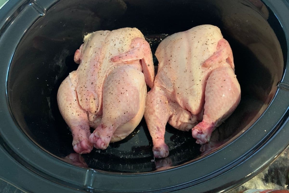 Two seasoned hens in the slow cooker.