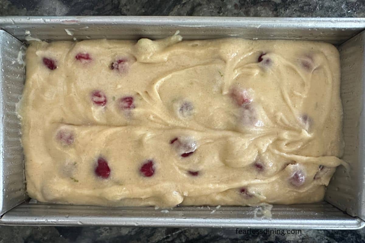 The cake batter in a greased loaf pan.