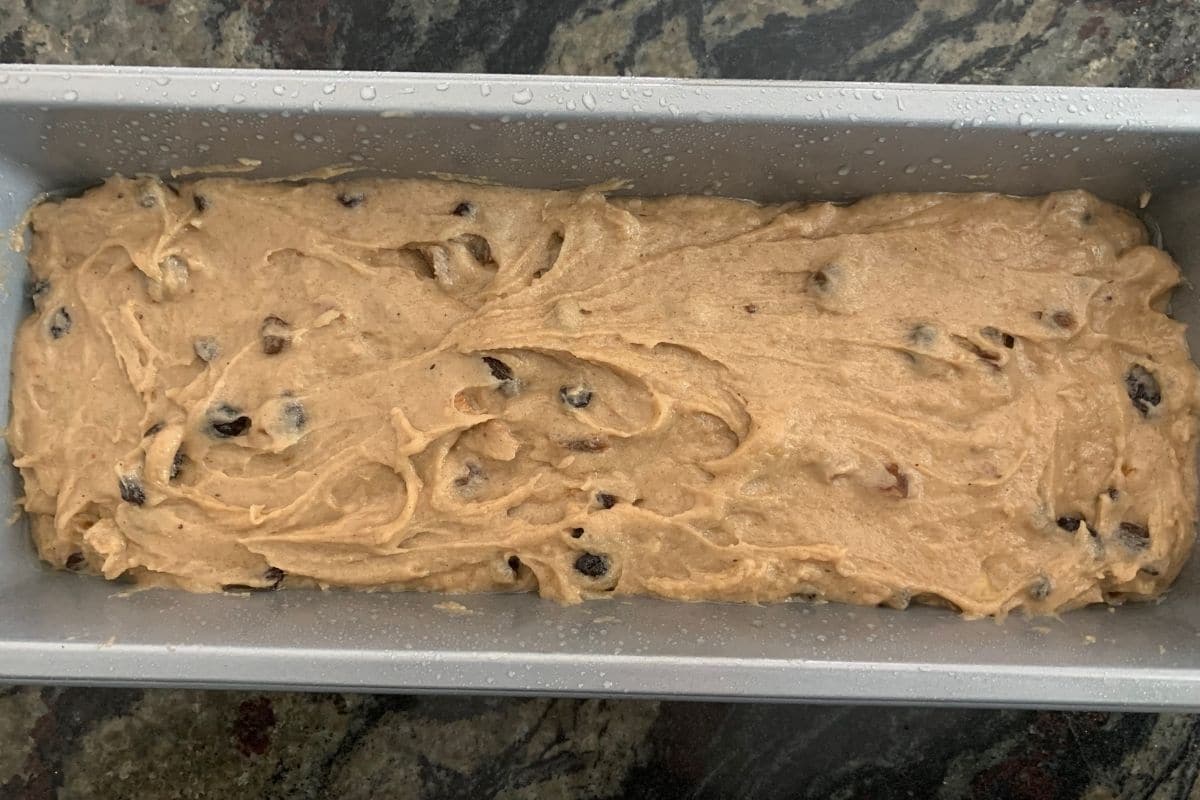 the fruit cake batter in a loaf pan ready to bake.