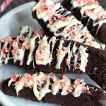 a plate with four chocolate peppermint biscotti slices.
