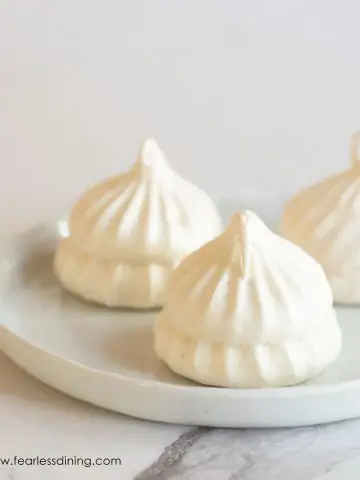 Three meringues on a white plate
